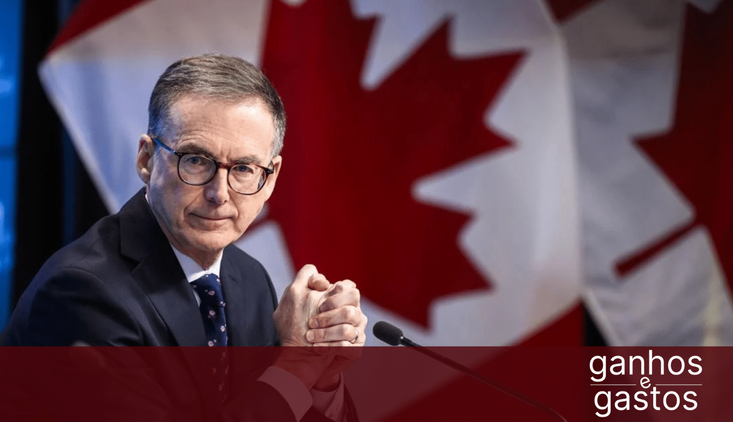 Bank of Canada Governor at press conference with Canadian flag in background, discussing interest rates, mortgage rates, and housing affordability